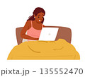 Young woman with excited and joyful expression on face using laptop sitting in cozy home bed 135552470