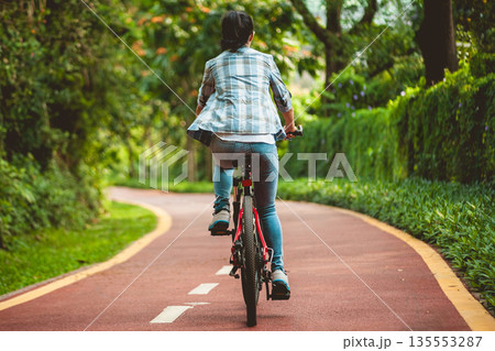 Fitness woman cycling in the park 135553287