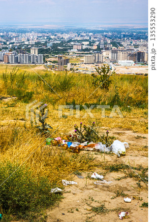 Scattered litter on dry hillside overlooking Bishkek city in Kyrgyzstan Scattered litter on dry hillside overlooking Bishkek city in Kyrgyzstan 135553290