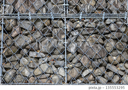 Gabion Wire Mesh Filled with Rocks, steel net as security against falling rocks. Gabion Wire Mesh Filled with Rocks, steel net as security against falling rocks. 135553295