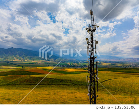Telecommunications Tower in Rural Landscape with Distant Mountains 135553300