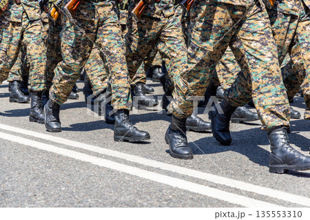 Group of soldiers marching in camouflage uniforms outdoors Group of soldiers marching in camouflage uniforms outdoors 135553310