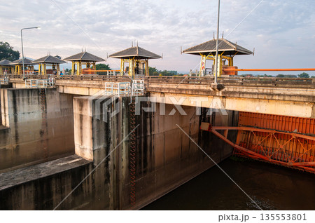 Behind the floodgates of small dam closed to protect the water flowing through. 135553801