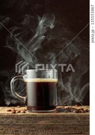 Black coffee in a clear glass mug. Black coffee in a clear glass mug. 135553867