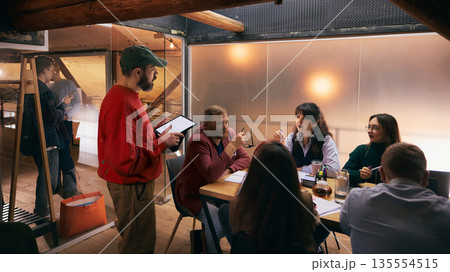 Creative professionals brainstorming together in modern office interior. Creative professionals brainstorming together in modern office interior. 135554515
