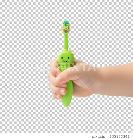Close-up of a small toddler's hand firmly gripping a green fun dinosaur or t-rex themed toothbrush, promoting early dental care habits Close-up of a small toddler's hand firmly gripping a green fun dinosaur or t-rex themed toothbrush, promoting early dental care habits 135555341