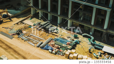 Aerial view of resort construction site with heavy machinery and partially built structures 135555458
