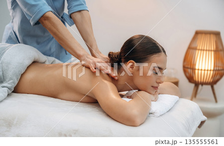 Neck massage. Relaxed young woman is with therapist in spa salon 135555561