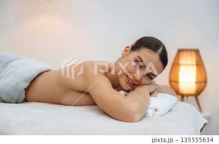Relaxing, waiting. Beautiful young woman lying on a couch in a spa salon Relaxing, waiting. Beautiful young woman lying on a couch in a spa salon 135555634