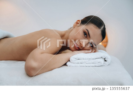 Conception of body care. Beautiful young woman lying on a couch in a spa salon 135555637