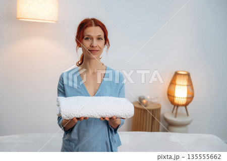 Fresh towels. Dermatologist, also skilled as a cosmetologist and beautician, poses for a portrait in beauty salon office Fresh towels. Dermatologist, also skilled as a cosmetologist and beautician, poses for a portrait in beauty salon office 135555662