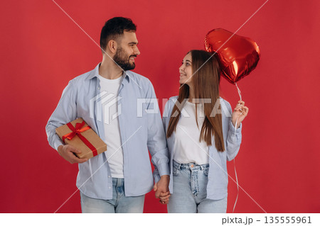 Front view, holding hands. Lovely couple are together in the studio 135555961