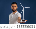 Electrician is holding wind generator toy, conception of eco energy 135556031