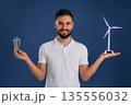 Electrician is holding wind generator toy, conception of eco energy 135556032