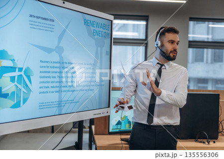 Renewable energy, coach. Man is working in the wind turbine company Renewable energy, coach. Man is working in the wind turbine company 135556306