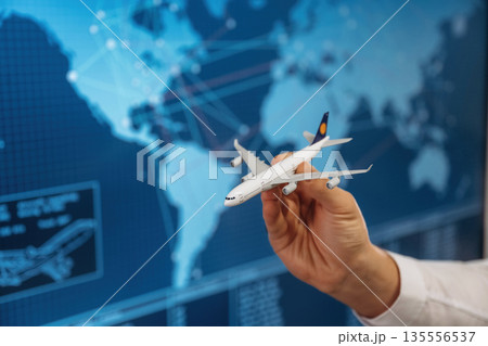 Close up view of hand that is holding toy plane 135556537