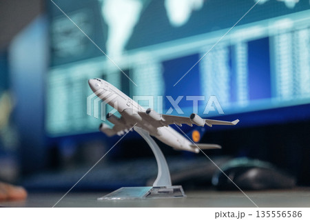 Close up focused view of toy plane on desk in airline company 135556586