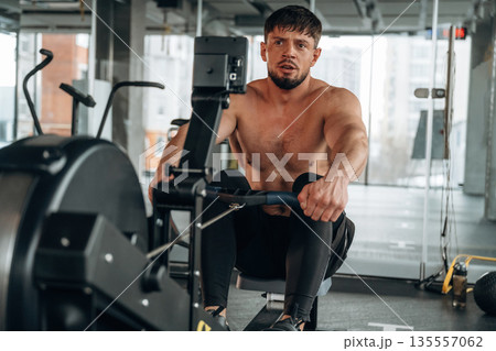 Preparing, doing cardio. Man is in the modern gym Preparing, doing cardio. Man is in the modern gym 135557062