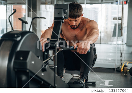 Preparing, doing cardio. Man is in the modern gym Preparing, doing cardio. Man is in the modern gym 135557064