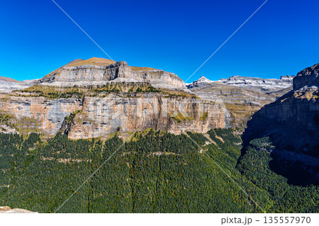 Walking on the Hunter's Trail, Senda de los Cazadores in autumn. Ordesa and Monte Perdido Natural Park, Pyrenees, Spain 135557970