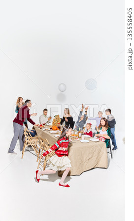 Relaxed family gathering with playful children during meal. Relaxed family gathering with playful children during meal. 135558405
