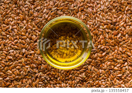 Brown linseed or flaxseed and oil. Healthy flax seed. Top view. Brown linseed or flaxseed and oil. Healthy flax seed. Top view. 135558457