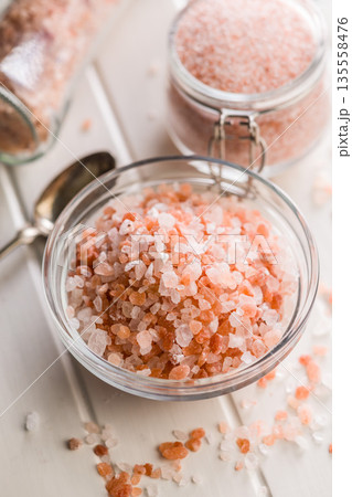 Pink Himalayan salt in bowl on white table. Pink Himalayan salt in bowl on white table. 135558476