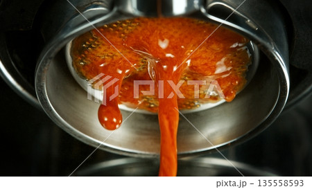 Macro Shot of Espresso Extraction from Naked Portafilter 135558593