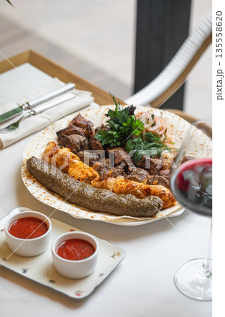 Grilled mixed shashlik assortment on lavash plate 135558620