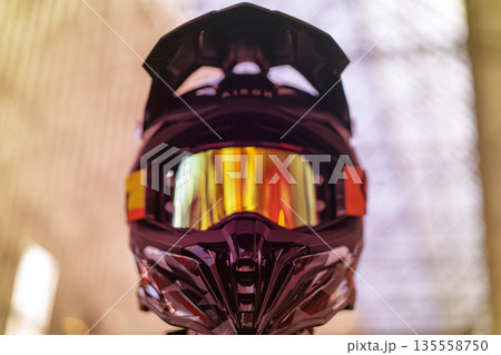 Closeup of black motocross helmet with reflective visor 135558750