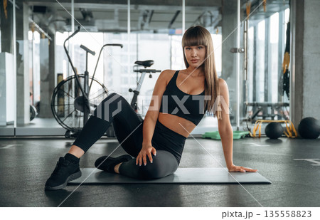Taking a break, sitting. Young woman is in the gym 135558823