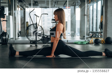 Wide twine. Young woman is in the gym Wide twine. Young woman is in the gym 135558827