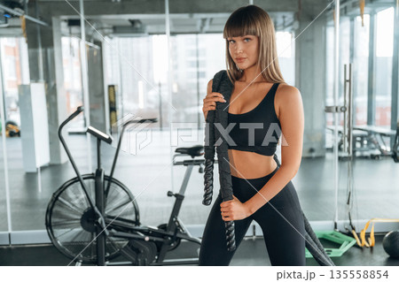 Big knot in hands on shoulder. Young woman is in the gym Big knot in hands on shoulder. Young woman is in the gym 135558854