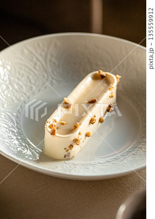Creamy mousse dessert with nuts on plate Creamy mousse dessert with nuts on plate 135559912