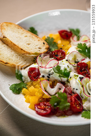 Salad with stracciatella cheese tomatoes herbs Salad with stracciatella cheese tomatoes herbs 135559933