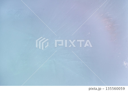 A background of delicate blue and pink ice with a subtle texture. A soft pastel abstract texture with a subtle glow 135560059