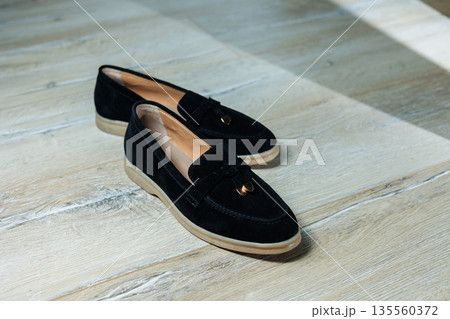 Women's black loafers without a heel for every day. Collection of summer women's shoes. Stylish women's shoes for the summer 135560372