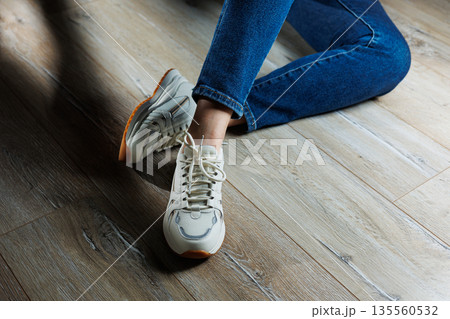 Collection of women's leather shoes. Female legs in leather white casual sneakers. Stylish women's sneakers Collection of women's leather shoes. Female legs in leather white casual sneakers. Stylish women's sneakers 135560532