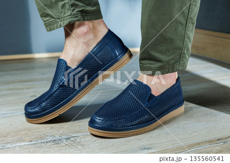 Male legs in blue leather shoes. Men's classic shoes. Male legs in blue leather shoes. Men's classic shoes. 135560541