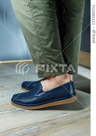 Male legs in blue leather shoes. Men's classic shoes. Male legs in blue leather shoes. Men's classic shoes. 135560552