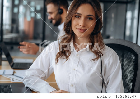 Portrait of gorgeous female. Man and woman are working in the office 135561347