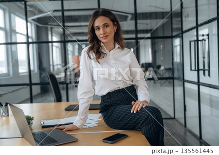 On the table. Beautiful woman is in the office On the table. Beautiful woman is in the office 135561445