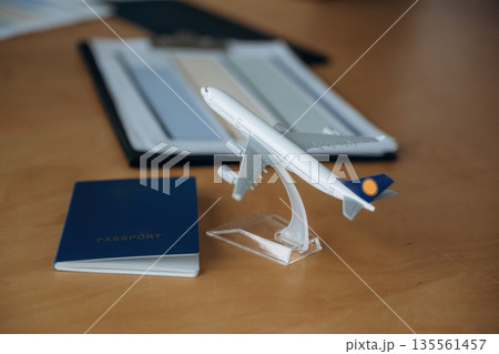 Focused detailed close up view of toy plane and passport Focused detailed close up view of toy plane and passport 135561457