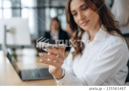 Showing model of plane. Business people are working in the office 135561487