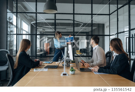 Gathering together. Business people are working in the office Gathering together. Business people are working in the office 135561542
