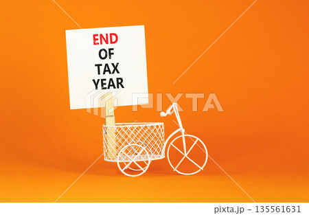 End of tax year symbol. Concept words phrase End of tax year on beautiful white paper on wooden clothespin. Bicycle. Beautiful orange paper background. Business End of tax year concept. Copy space. 135561631