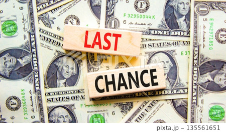 Last chance symbol. Concept word Last chance on beautiful wooden blocks. Dollar bills. Beautiful dollar bills background. Business last chance concept. Copy space. Last chance symbol. Concept word Last chance on beautiful wooden blocks. Dollar bills. Beautiful dollar bills background. Business last chance concept. Copy space. 135561651