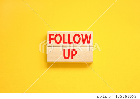 Follow up symbol. Concept word Follow up on beautiful wooden blocks. Beautiful yellow paper background. Business follow up concept. Copy space. Follow up symbol. Concept word Follow up on beautiful wooden blocks. Beautiful yellow paper background. Business follow up concept. Copy space. 135561655