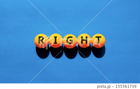 Right symbol. Concept word Right on beautiful yellow tennis ping pong balls. Beautiful wooden table wooden background. Business lifestyle right concept. Copy space. 135561739