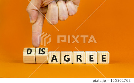 Agree or disagree symbol. Concept words Agree Disagree on beautiful wooden blocks. Beautiful orange table orange background. Businessman hand. Business agree or disagree concept. Copy space Agree or disagree symbol. Concept words Agree Disagree on beautiful wooden blocks. Beautiful orange table orange background. Businessman hand. Business agree or disagree concept. Copy space 135561762